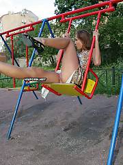 Lovely nymph sitting on swings and flashing lovely pussy, Then she walks around and and exposing breathtaking exciting views of nude twat upskirt