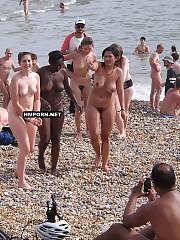 Nudist and naturist girls walking nude and spreading legs wide, being caught by voyeurist cameras on worldwide beaches