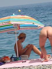 Nudist and naturist women getting caught sunbathing nude by voyeurists and in this post their creamy asses and cunts are pictured from behind