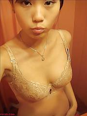Sexy oriental babe enjoys naked selfshot.