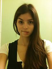 Pretty dark haired teen filming herself.